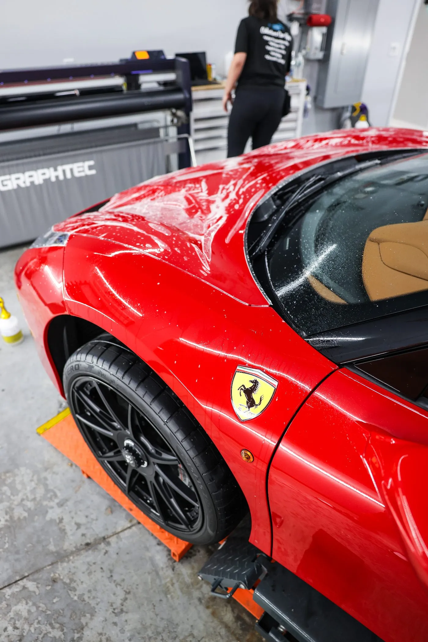 Paint protection film installation on a Ferrari 488 at Collectors Car Spa in Orlando